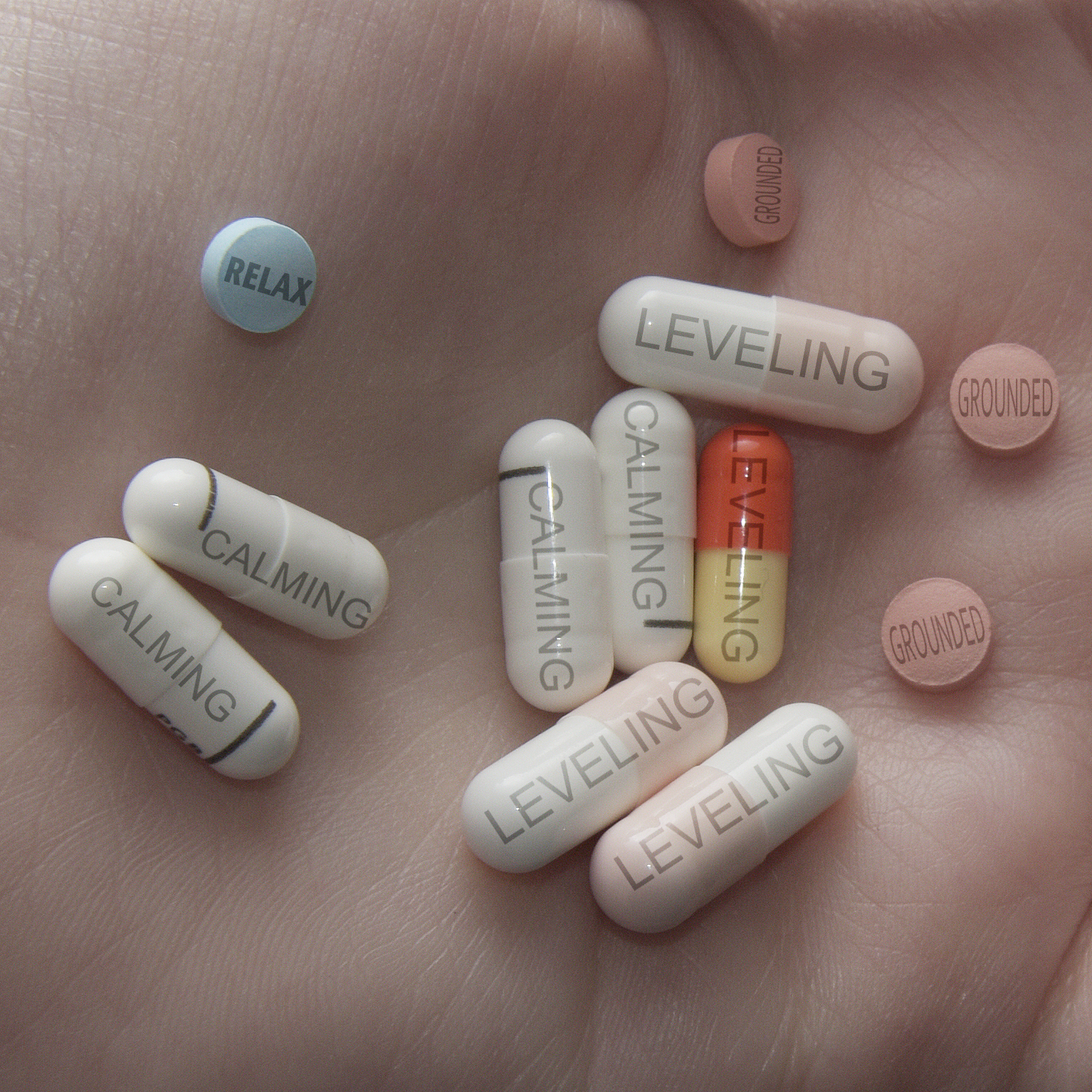 Image of pills, with words like Calming and Levelling on them